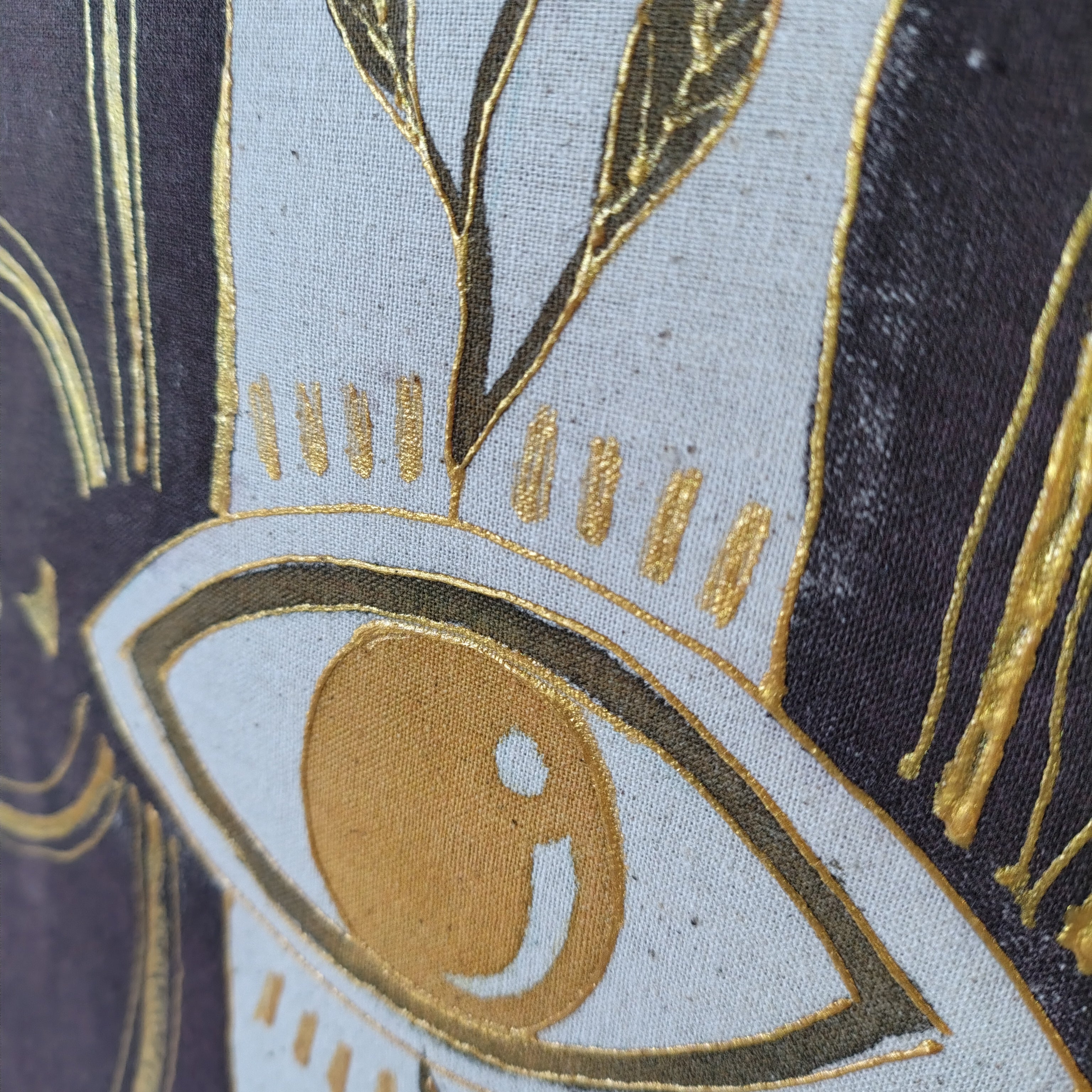 Close-up of decorative fabric with gold embroidery on a blue and black background