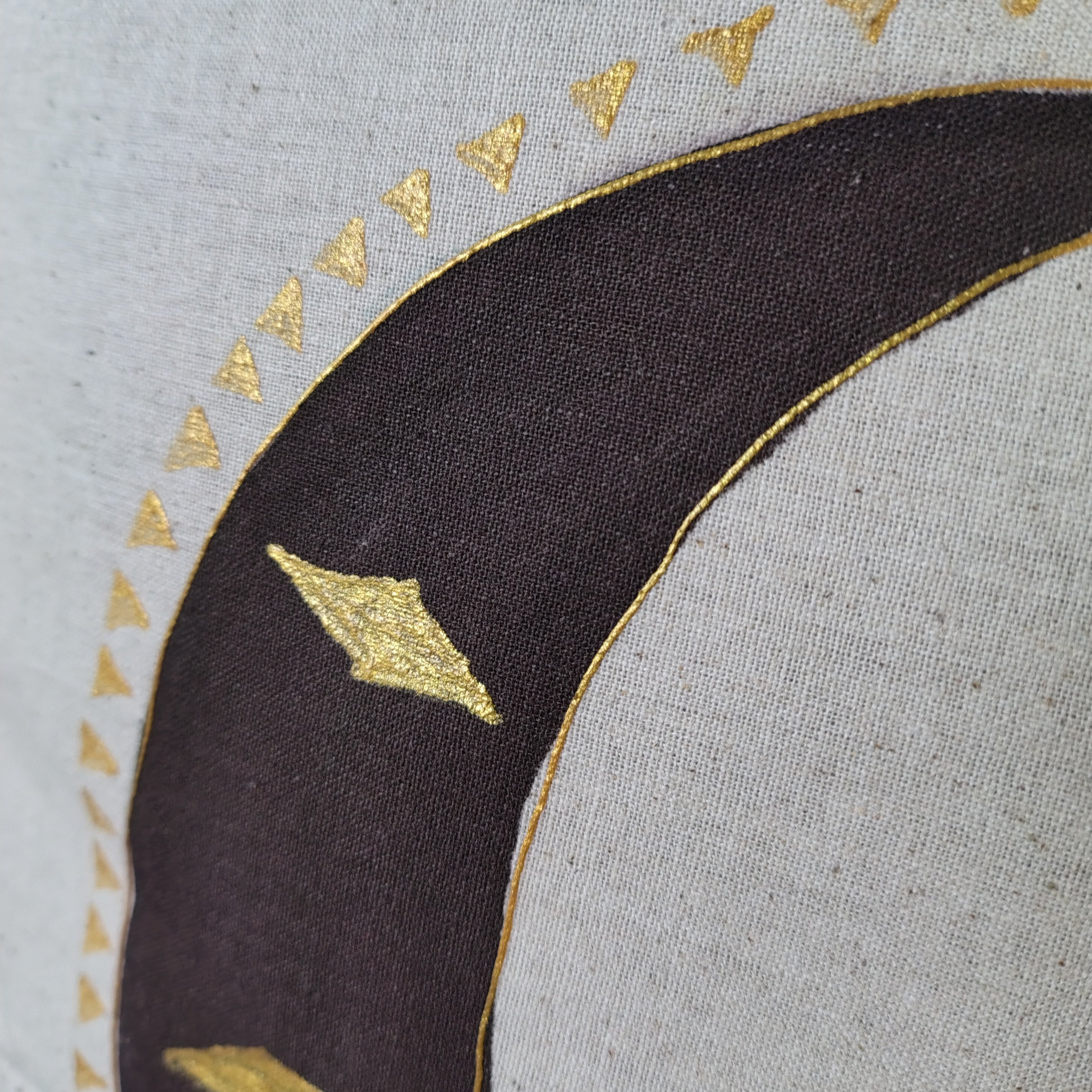 Decorative border with gold triangles on a textured fabric background
