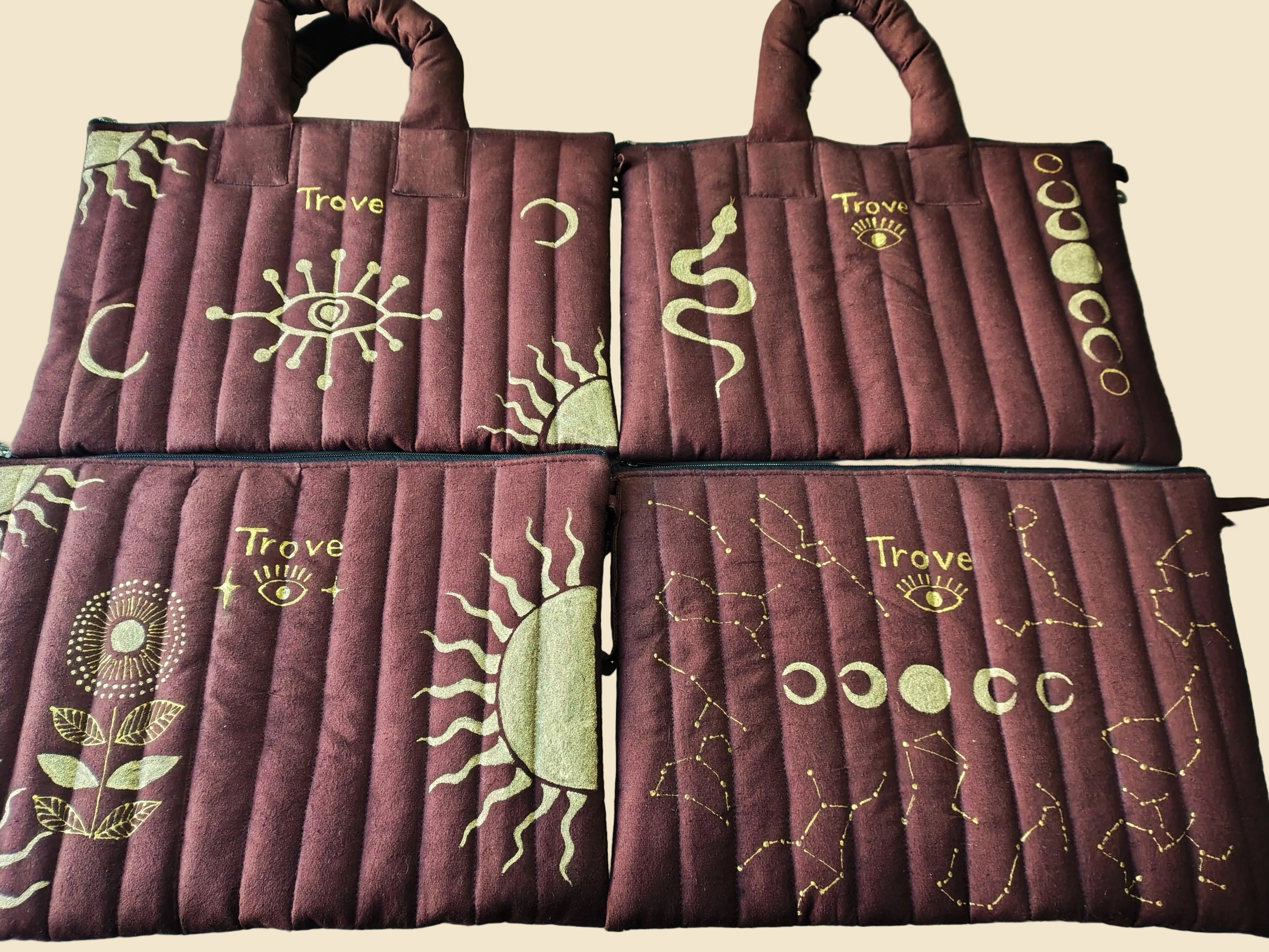 Set of four maroon bags with gold designs and 'Trove' branding on a light green background.