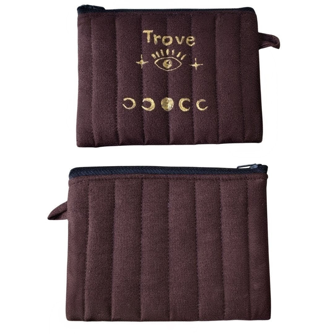 Brown pouch with 'Trove' branding and gold designs on a white background . luxurious bag