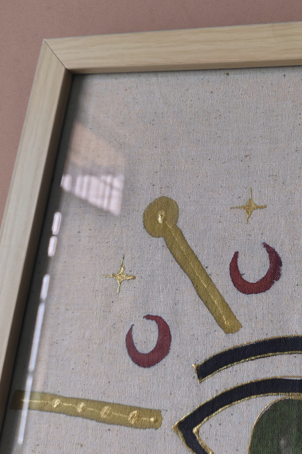 Decorative design with gold, red, and black elements on a textured surface.