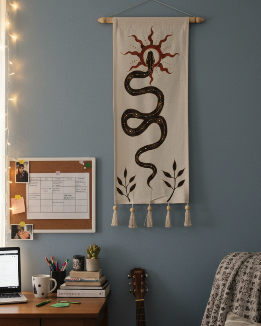Decorative wall hanging with snake design on a blue wall above a desk. spiritual, aesthetic, luxury decor.