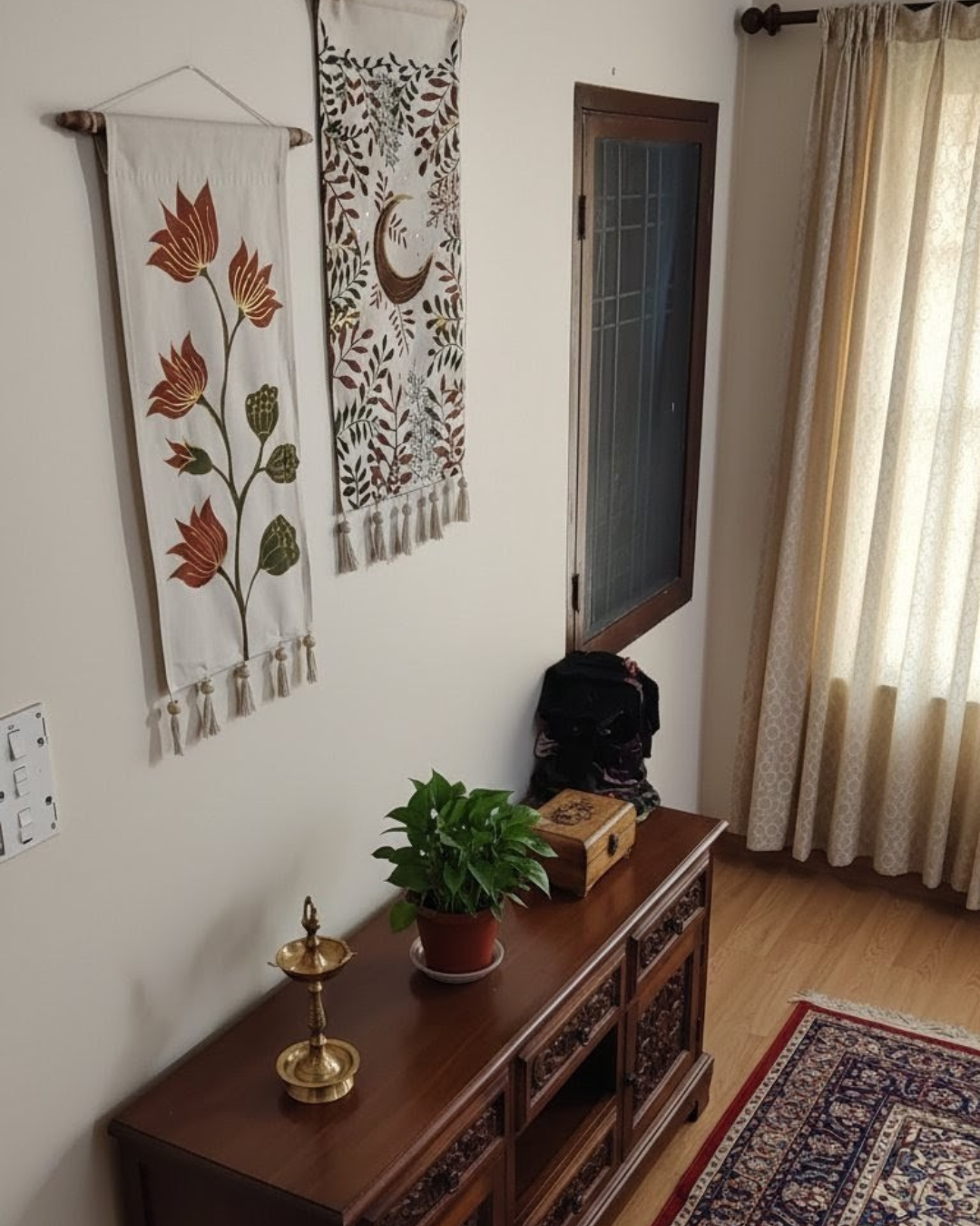 Room interior with a wooden cabinet, decorative items, and wall hangings.