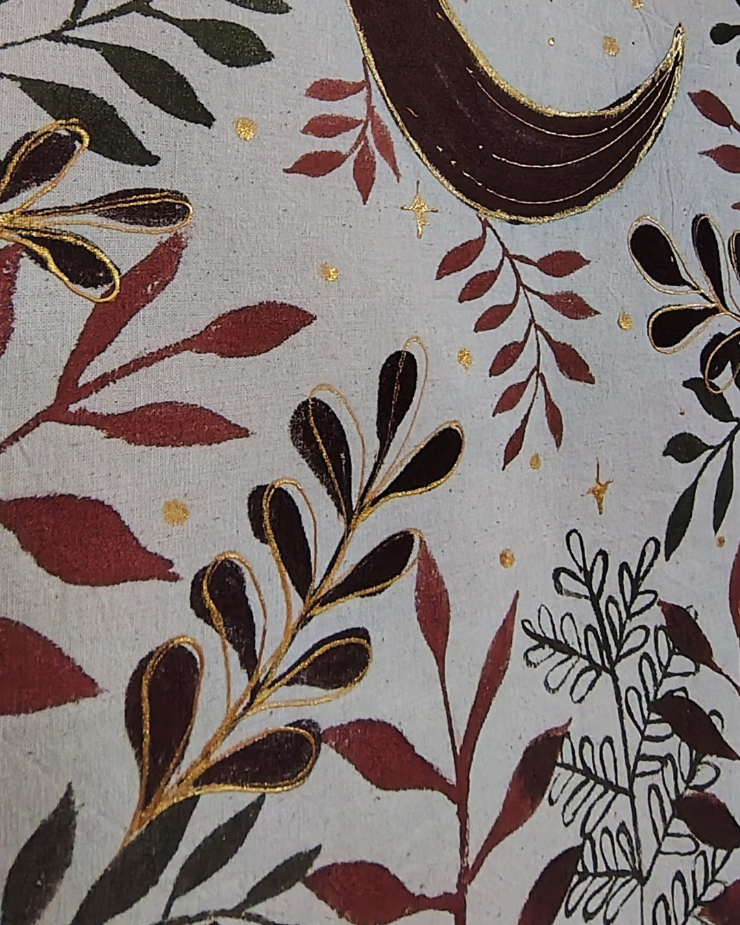 Patterned fabric with leaves, flowers, and abstract shapes on a gray background