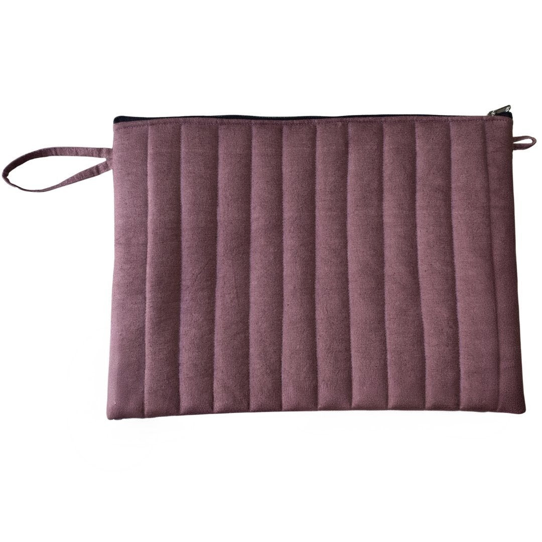 Purple clutch bag with a strap on a white background