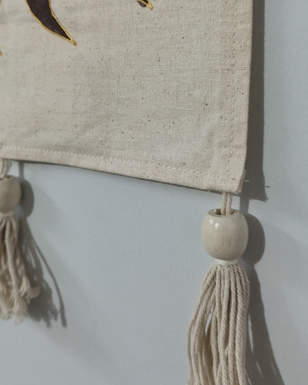 Textile item with tassels and a decorative bead on a plain background. hand painted room decor luxury item, best for gift