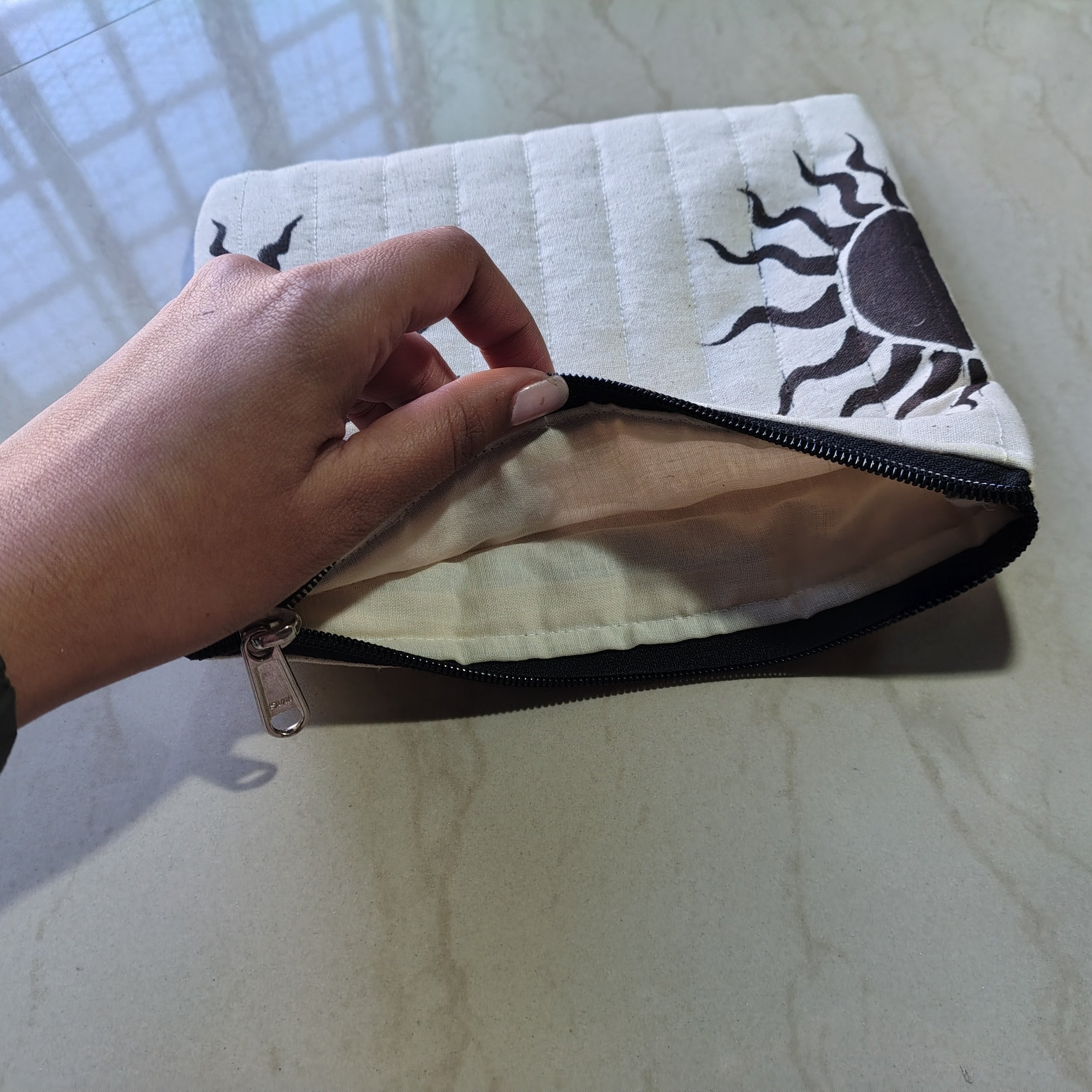 white hand painted and hand made makeup pouch with sun motif